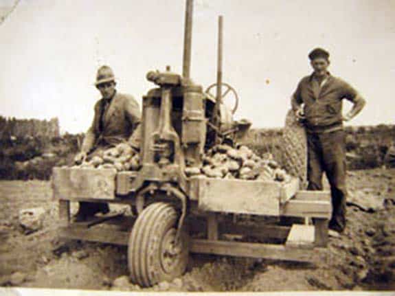 George Green and Archie Oliver, employees of Walter Mark Oakley, planting potatoes with a Farmhall F12 Tractor, 1933.