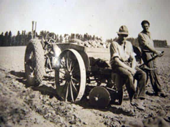  George Green and Archie Oliver planting potatoes with a two row planter built by Walker Mark Oakley where he joined two single row planted together, 1935.